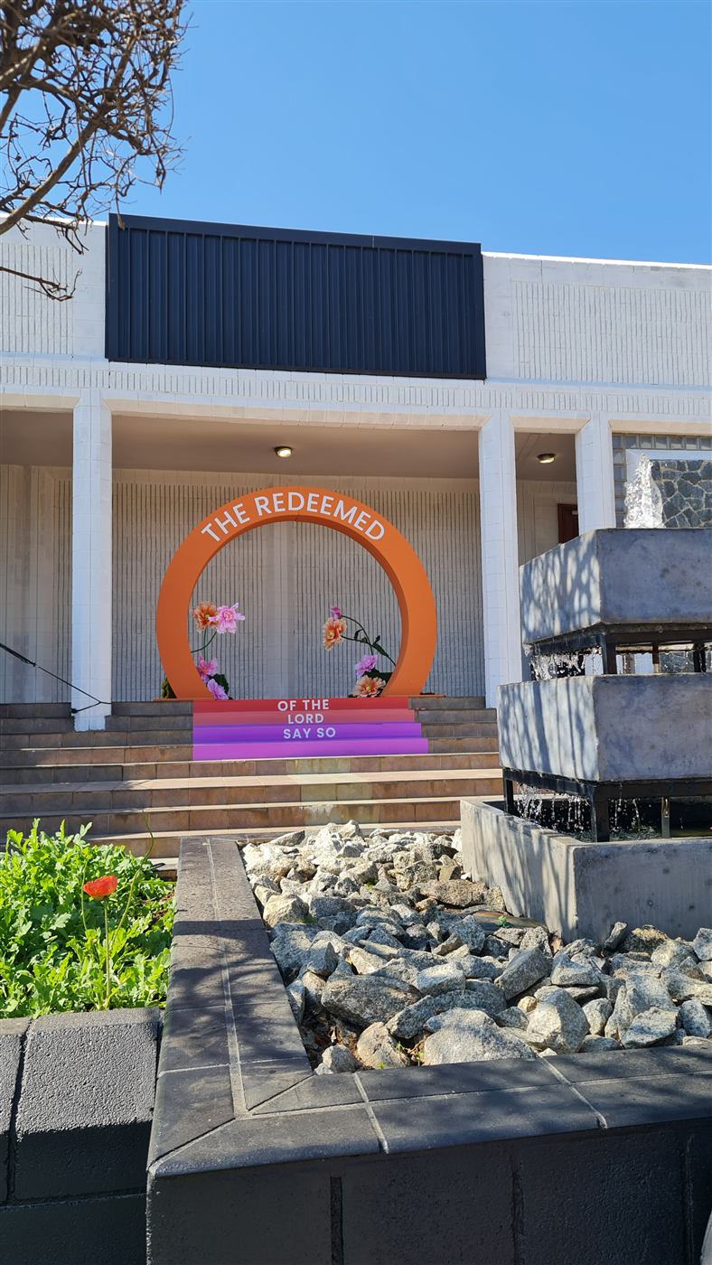 Wide shot of a large orange circular event arch outdoors