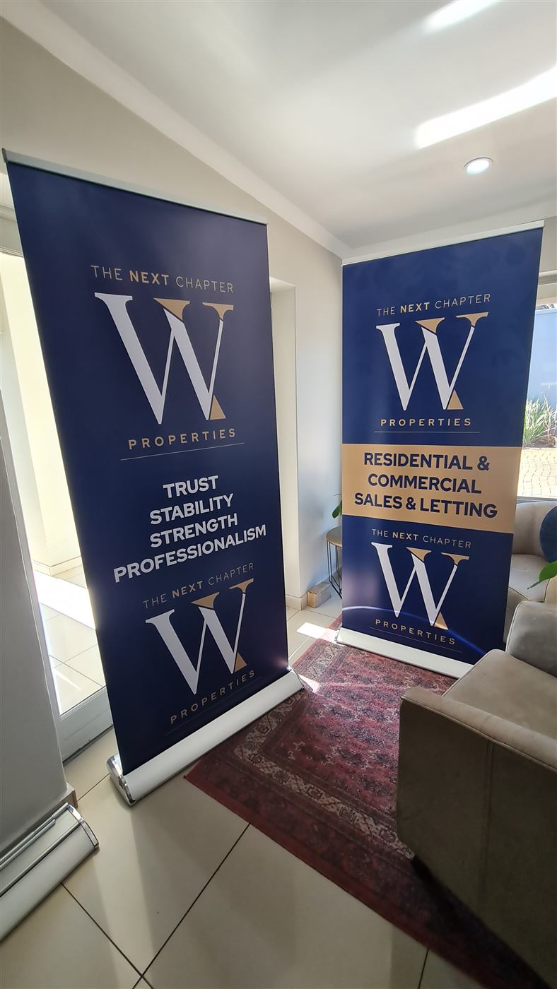 Pull-up roller banners for a property brand exhibition stand