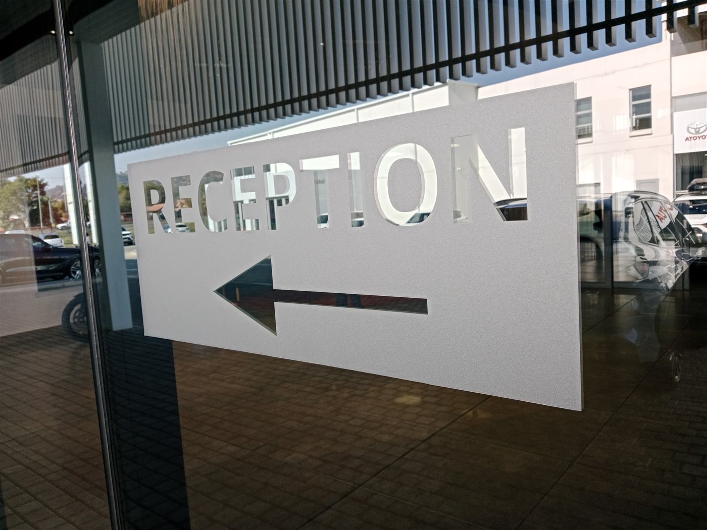 Reception directional arrow signage on glass